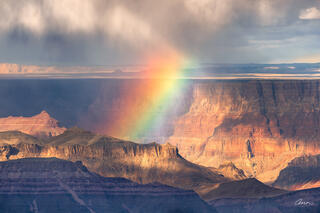 Grand Canyon with a rainbow rising from deep below.