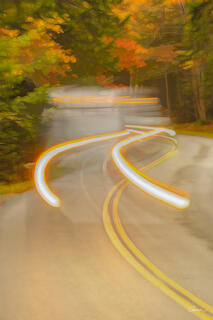 Fun abstract of car lights swerving on an autumn drive in Acadia National Park.