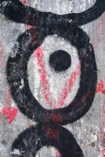 Close-up of graphic street graffiti in black circles, red lines, and white and gray background that looks like a CrossFit deadlift.
