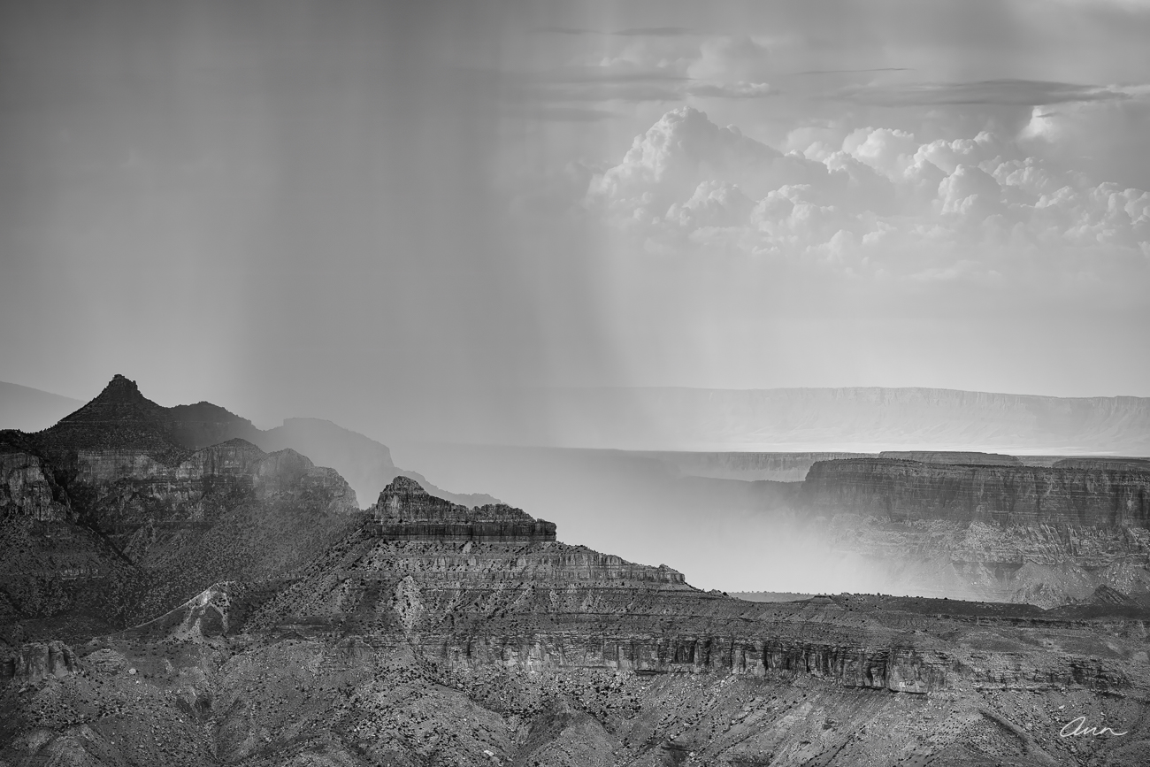 A summer storm unloads over a butte at the south rim of the Grand Canyon. There's a free car wash, it's just a little tough to...