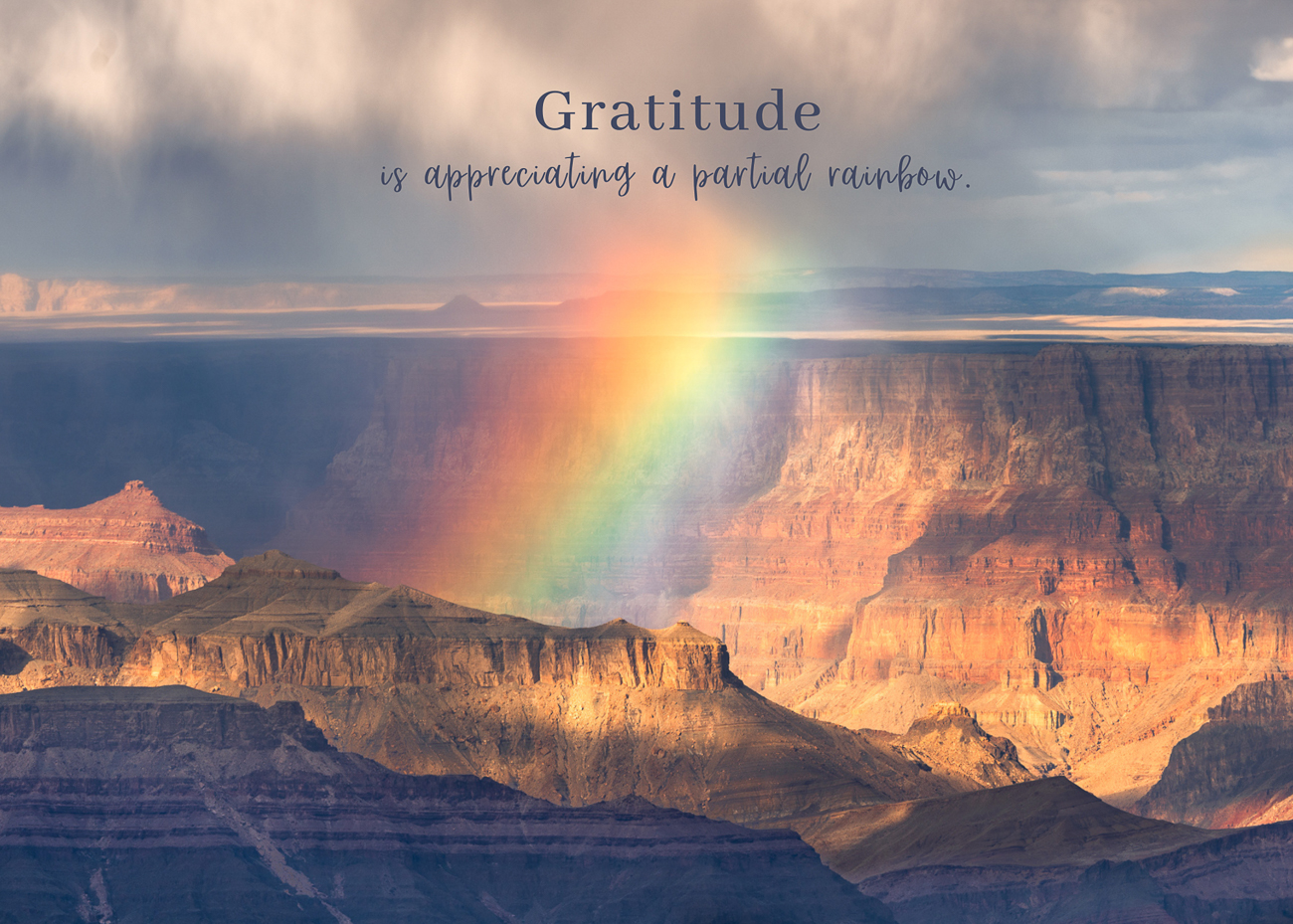 A photo of a rainbow over the Grand Canyon with a quote about gratitude.