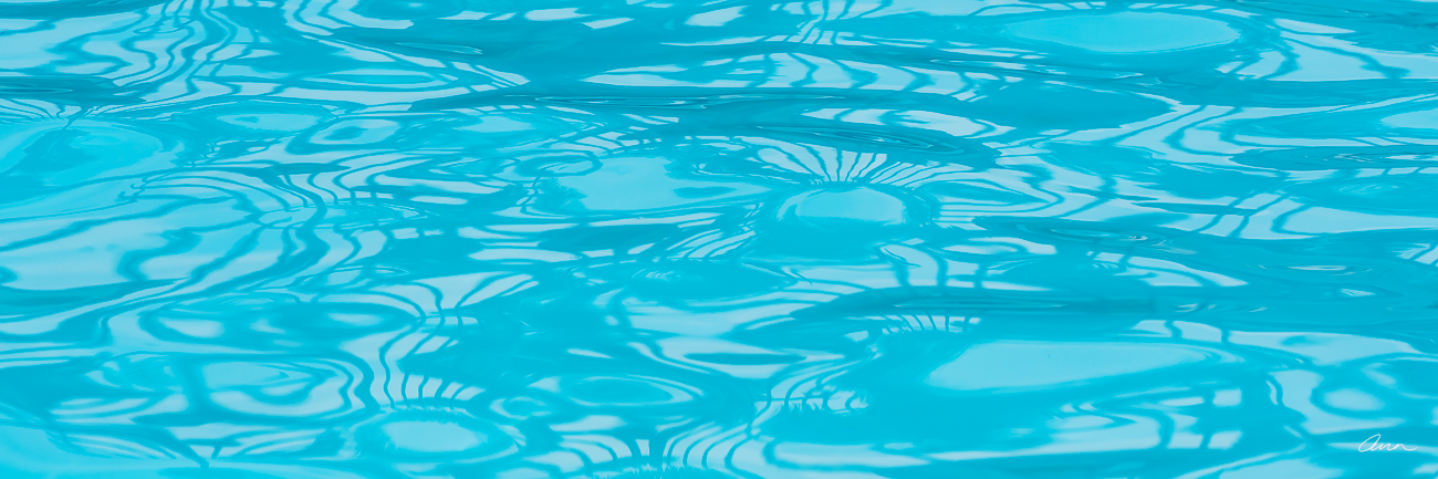 Wavy turquoise pool surface reflecting lines and patterns