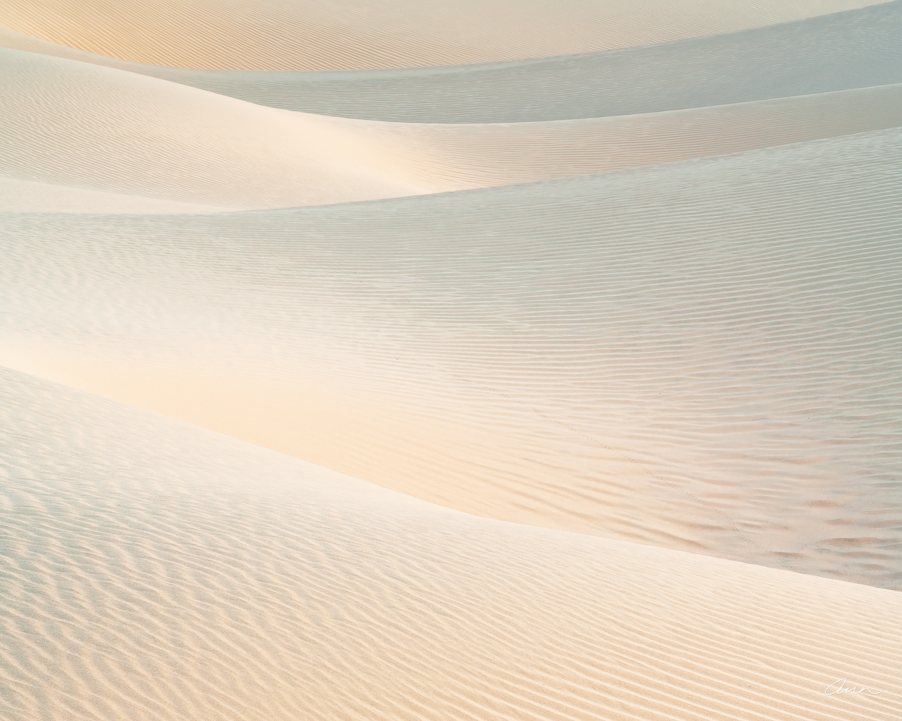 Sand dune layers look like silky tousled sheets.