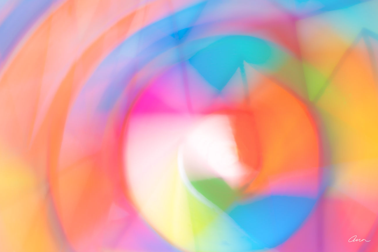Defocused gradient colors flow to create a circular pattern with lines and angles. Having curves and edges is all about balance...